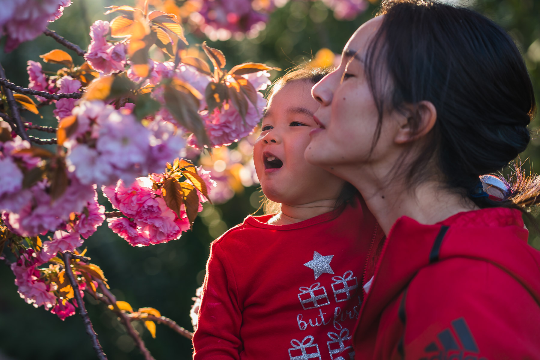 mom and daughter enjoying sakura 